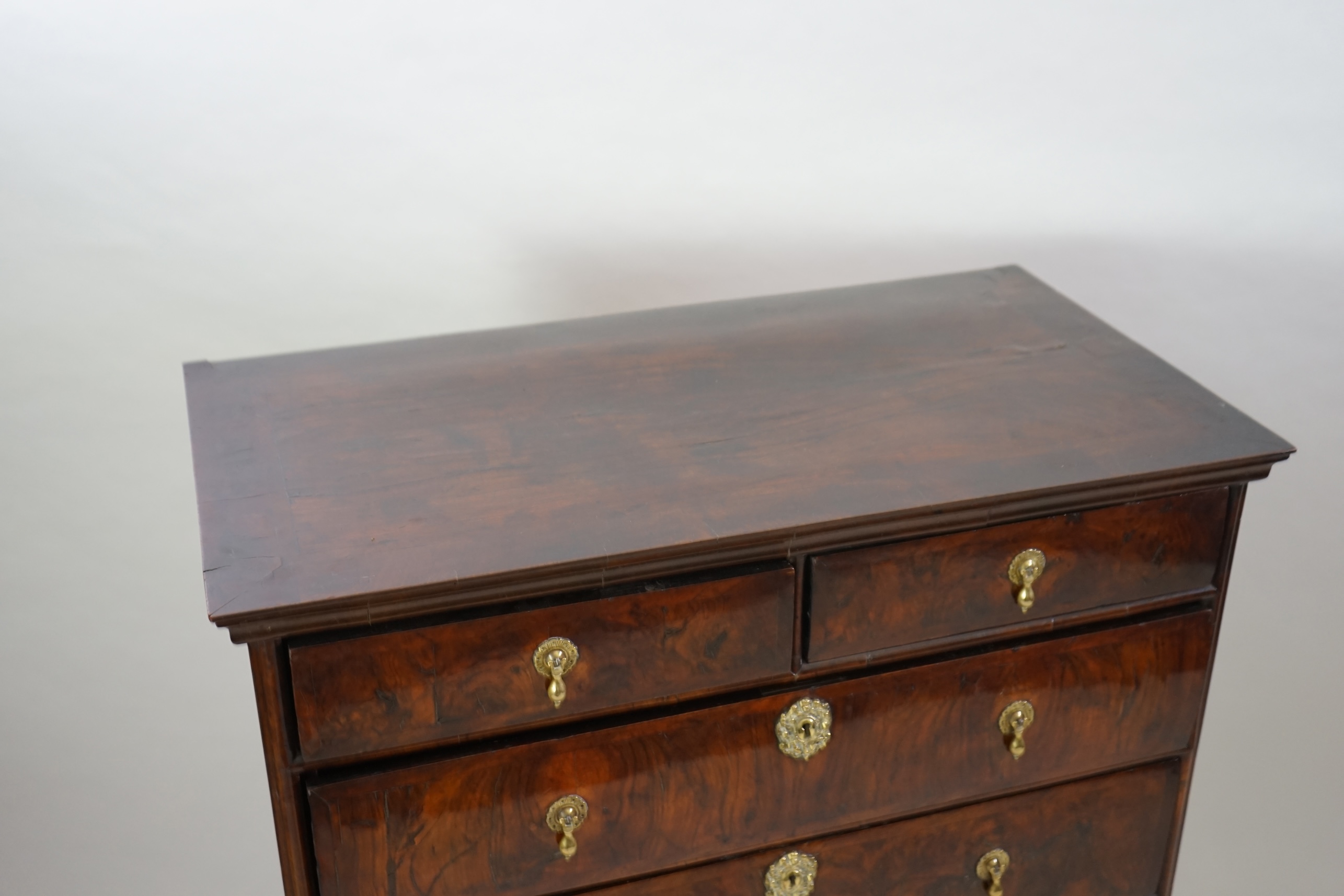 An early 18th century and later crossbanded walnut chest on stand